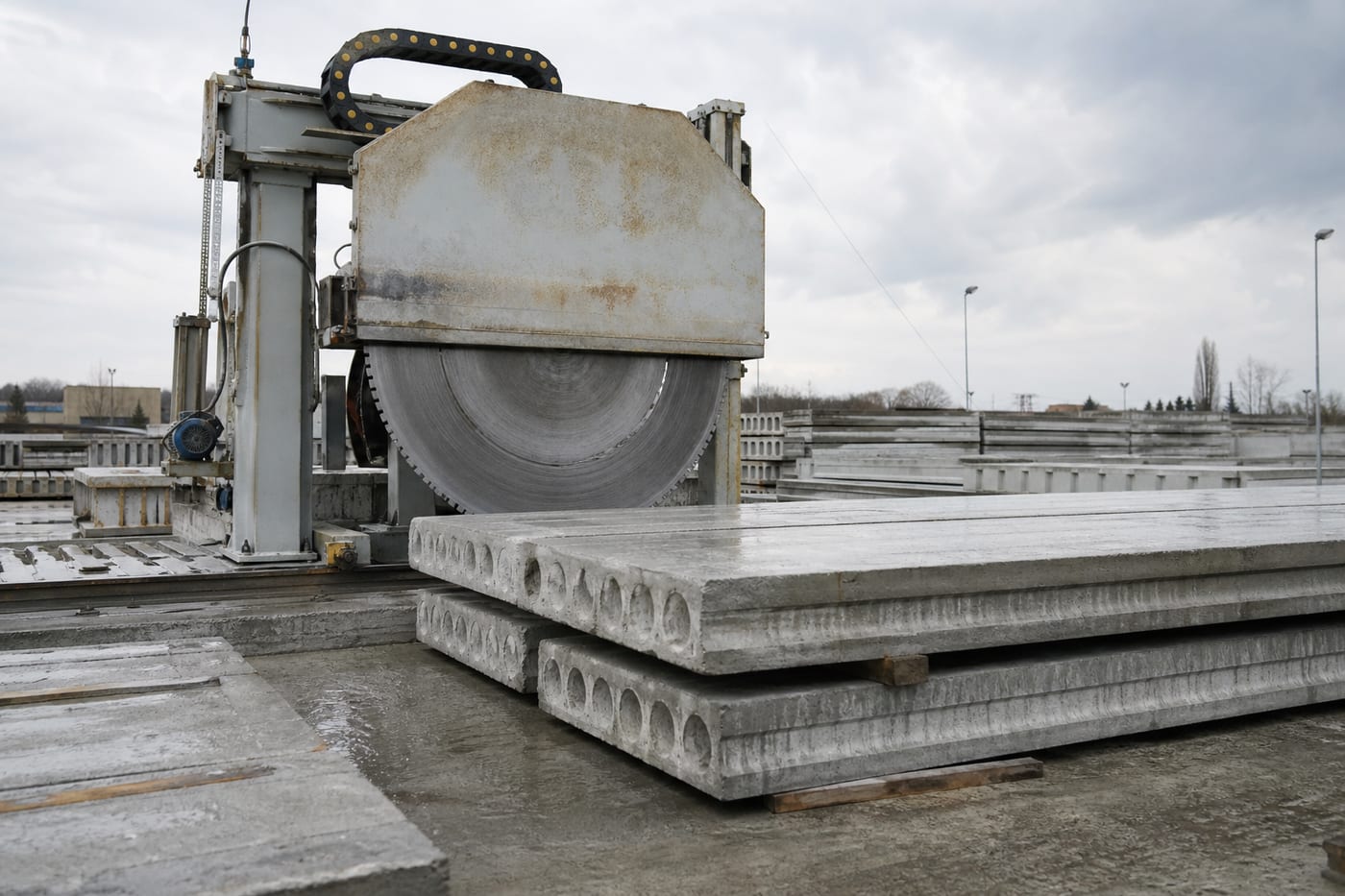 Industrial diamond saw next to hollow-core prestressed concrete slabs